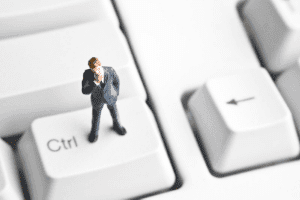 man on keyboard considering ISO 27001 misconceptions